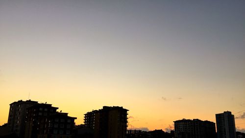 Low angle view of buildings at sunset
