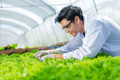 Young botanist working in greenhouse