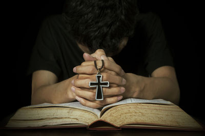 Midsection of man praying