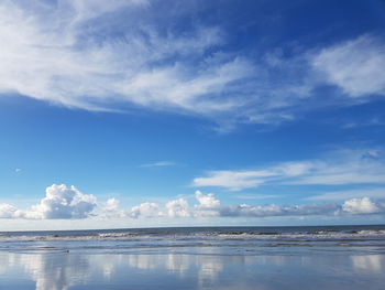 Scenic view of beach against blue sky