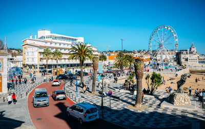 View of ferris wheel in city against sky