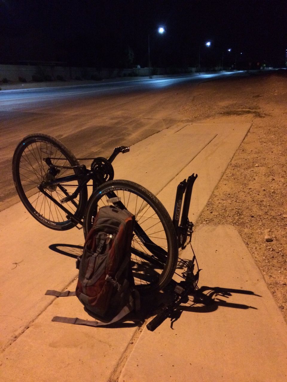 bicycle, transportation, land vehicle, mode of transport, stationary, parking, wheel, street, parked, shadow, outdoors, sunlight, road, night, no people, sand, travel, sidewalk, cycle