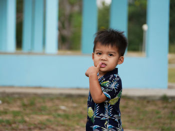 Portrait of cute boy standing outdoors
