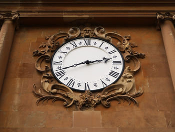 Low angle view of clock on wall