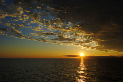 Scenic view of sea against romantic sky at sunset