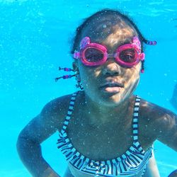 Portrait of happy girl swimming in pool