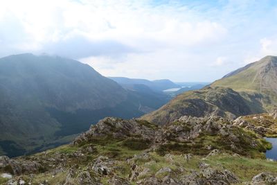 Scenic view of mountains against cloudy sky