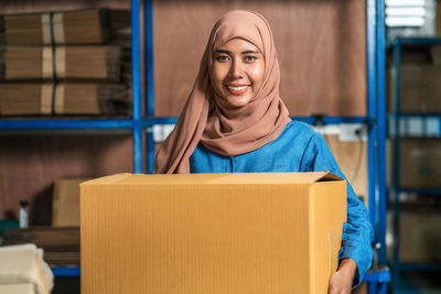 Portrait of a smiling young woman working in building