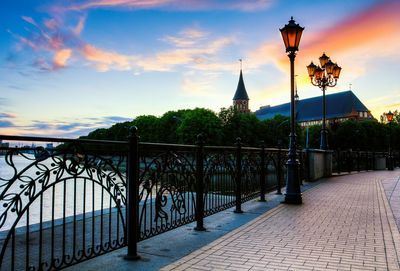 Silhouette of trees against cloudy sky at sunset