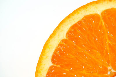 Close-up of orange slice against white background