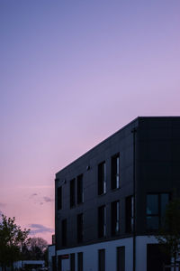 Low angle view of building against sky during sunset