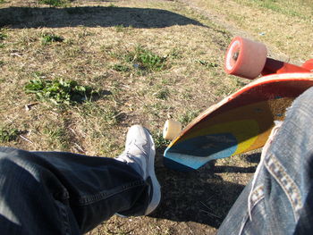 Low section of person wearing shoes on field