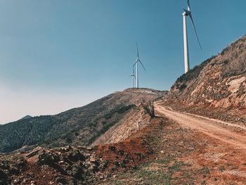 Windmill on mountain against sky