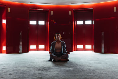 Rear view of woman sitting on stage