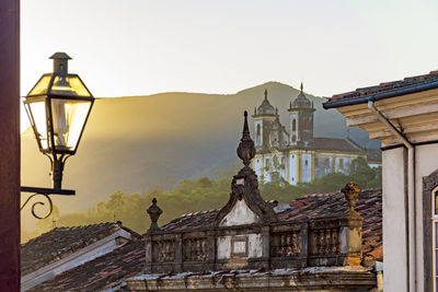 Facade of historic colonial style houses with their lanterns and church in the city of ouro preto