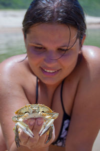 Portrait of a smiling young woman holding leaf