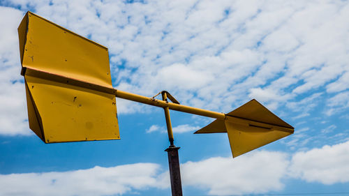 Low angle view of road sign against sky