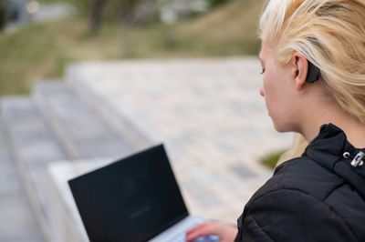 Portrait of woman using smart phone outdoors