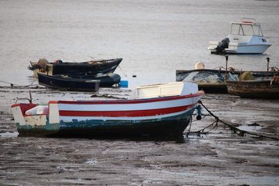 Boat moored on shore at harbor