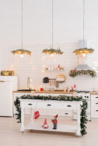 Winter cozy kitchen with red decorations, christmas kitchen table and utensils