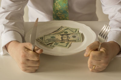 Close-up of human hand holding paper