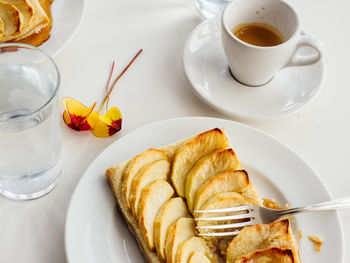 High angle view of apple tart and tea served on table