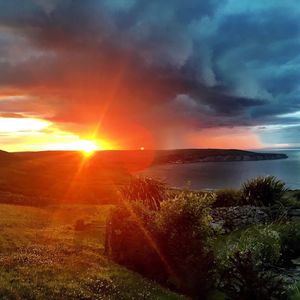 Scenic view of dramatic sky over landscape