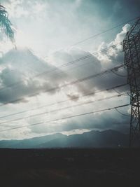 Low angle view of power lines against sky