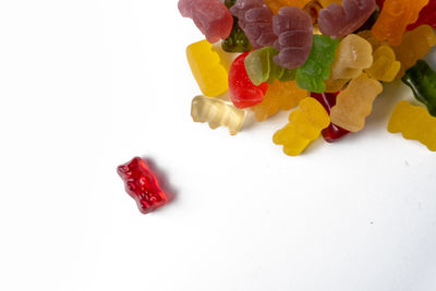 High angle view of multi colored candies on white background