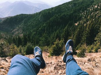 Low section of person dangling against mountain