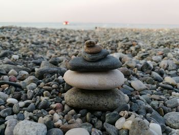 Close-up of pebbles on beach against sky