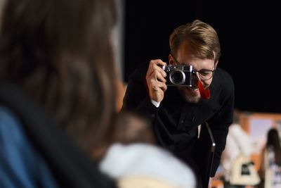 Close-up of man photographing woman