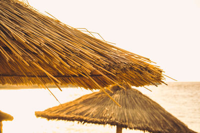 Low angle view of thatched roof against clear sky