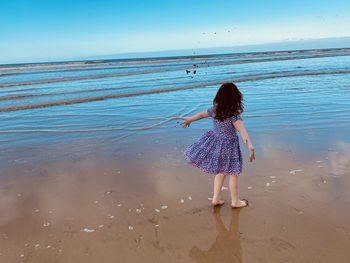 Rear view of woman on beach