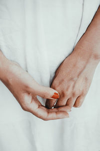 Close-up of woman hand holding white