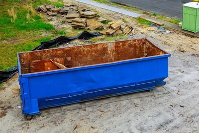 High angle view of blue rusty container on field