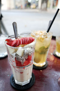 High angle view of dessert with fruits in glass on table