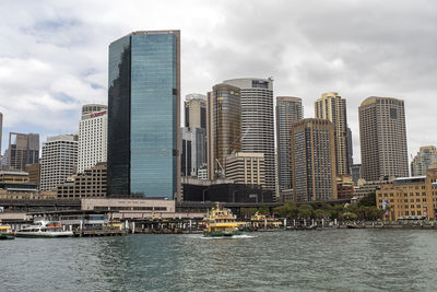 View of skyscrapers against cloudy sky