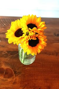 Close-up of yellow flower vase on table