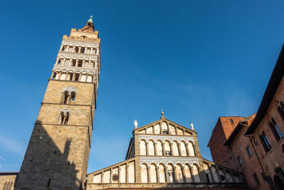 The elegant romanesque style facade and bell tower of pistoia cathedral, tuscany, italy