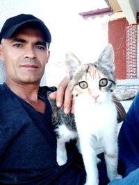Portrait of man with cat
