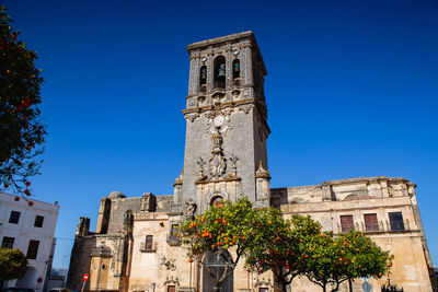 Low angle view of historic building against clear blue sky