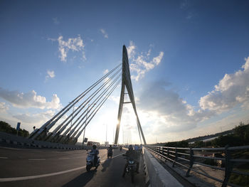 Bridge over road against sky in city