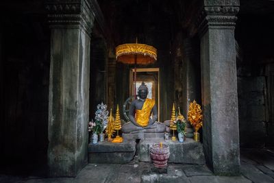 Rear view of woman standing in temple