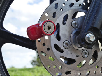 Close-up of machine part against sky