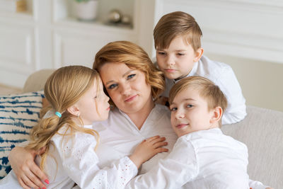 Cute kids hugging, excited mom showing love and affection, smiling mother