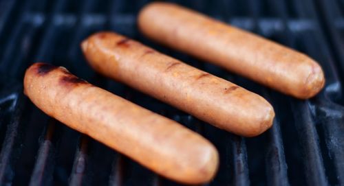 Close-up of hot dogs on a grill