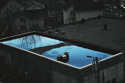 High angle view of swimming pool by buildings in city