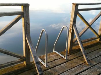 Close-up of railing against sky and water 