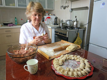 Woman preparing food in kitchen